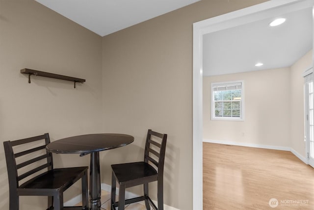 dining space with recessed lighting, wood finished floors, and baseboards