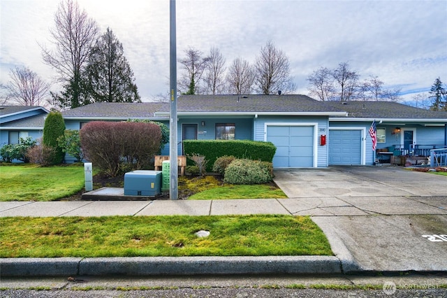 single story home featuring a garage, driveway, and a front yard