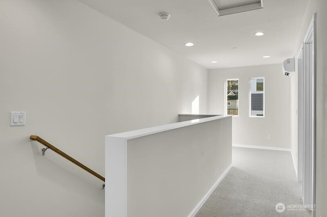 corridor featuring carpet, baseboards, an upstairs landing, and recessed lighting