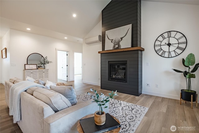 living area with recessed lighting, an AC wall unit, lofted ceiling, and wood finished floors