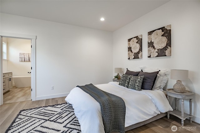 bedroom with recessed lighting, light wood-style flooring, and baseboards