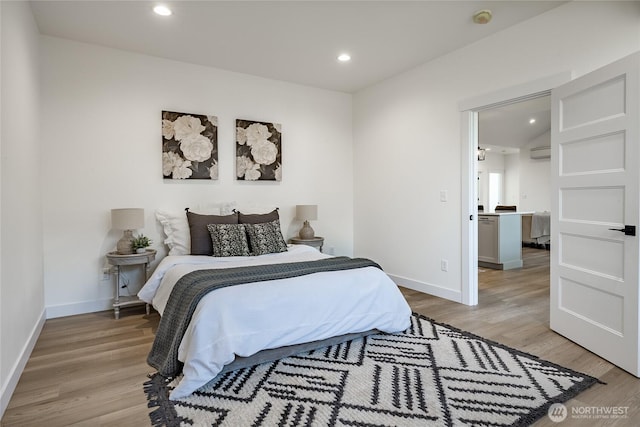 bedroom with recessed lighting, light wood-style flooring, and baseboards
