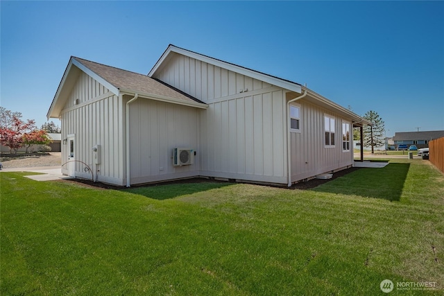 back of house with board and batten siding, a yard, a shingled roof, and ac unit