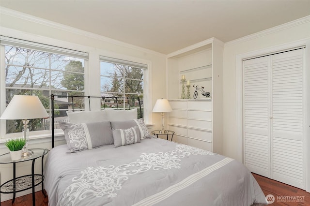 bedroom featuring ornamental molding, a closet, and wood finished floors