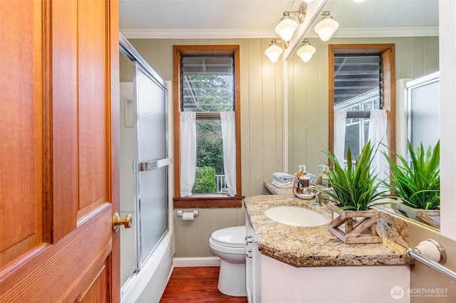 full bath featuring crown molding, toilet, an inviting chandelier, vanity, and wood finished floors