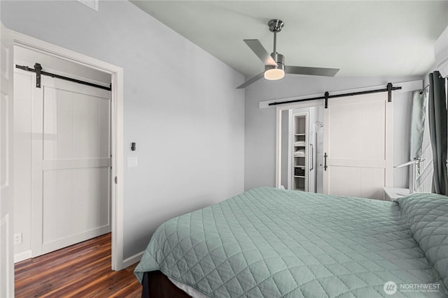 1000 Sr 150, Manson, WA 98831 - bedroom with a barn door, ceiling fan, dark wood finished floors, and baseboards