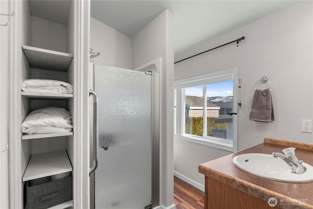 1000 Sr 150, Manson, WA 98831 - bathroom with vanity, a shower stall, wood finished floors, and baseboards
