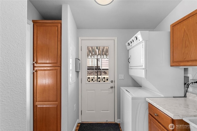 1000 Sr 150, Manson, WA 98831 - clothes washing area with stacked washer / dryer and cabinet space