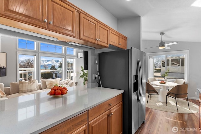 1000 Sr 150, Manson, WA 98831 - kitchen with wood finished floors, brown cabinets, stainless steel fridge, and a healthy amount of sunlight