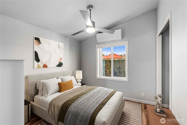 1000 Sr 150, Manson, WA 98831 - bedroom featuring wood finished floors, a ceiling fan, a wall mounted AC, and baseboards