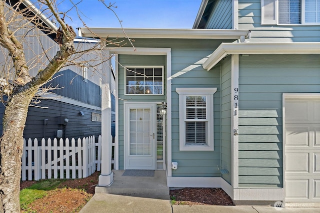 view of exterior entry with fence