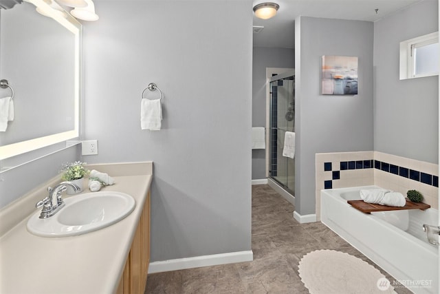 full bath featuring a garden tub, a shower stall, vanity, and baseboards