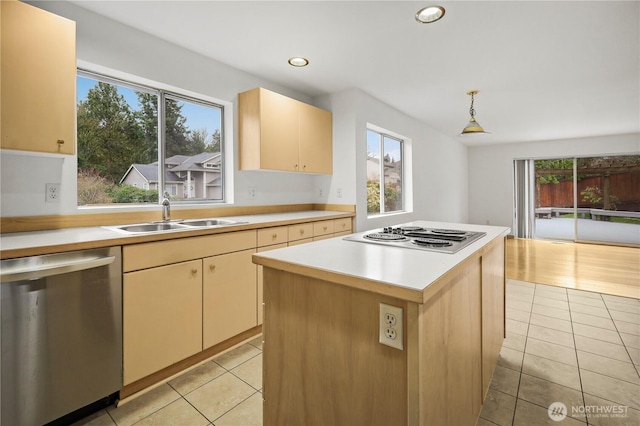 kitchen with pendant lighting, a sink, appliances with stainless steel finishes, light countertops, and light tile patterned floors