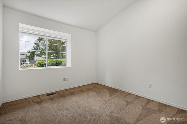 unfurnished room featuring lofted ceiling, carpet flooring, baseboards, and visible vents