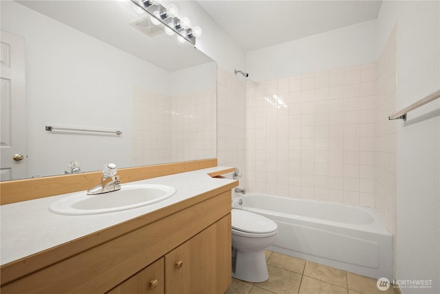 bathroom featuring toilet, bathtub / shower combination, vanity, and tile patterned flooring