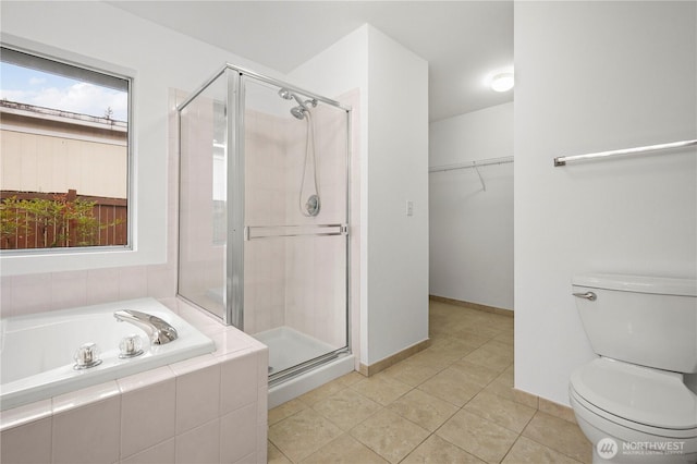 full bathroom featuring a wealth of natural light, toilet, a stall shower, and tile patterned floors