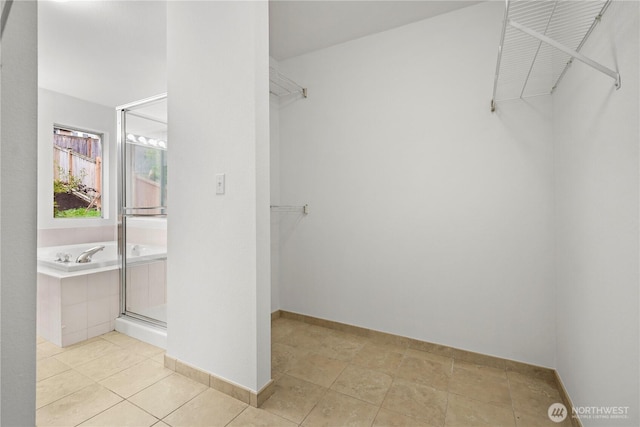 walk in closet featuring light tile patterned floors