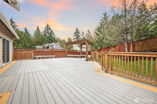 wooden terrace with a pergola and a fenced backyard