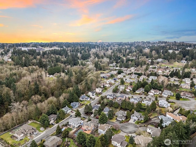 aerial view at dusk featuring a residential view