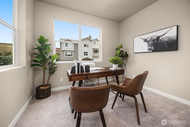 office with a healthy amount of sunlight, baseboards, and carpet flooring