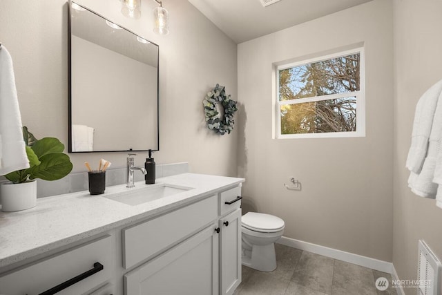 bathroom featuring visible vents, baseboards, toilet, tile patterned floors, and vanity