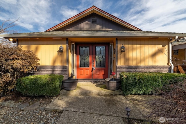 entrance to property featuring stone siding