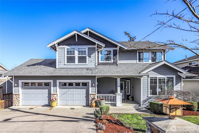 view of front facade with a porch, concrete driveway, and a shingled roof