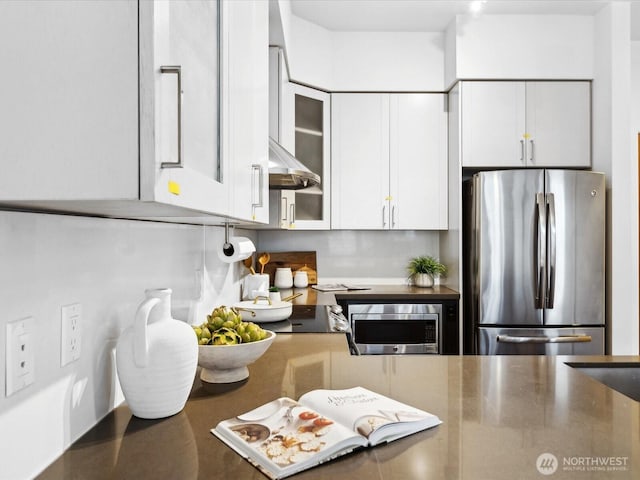 kitchen with stainless steel appliances, white cabinetry, glass insert cabinets, and ventilation hood