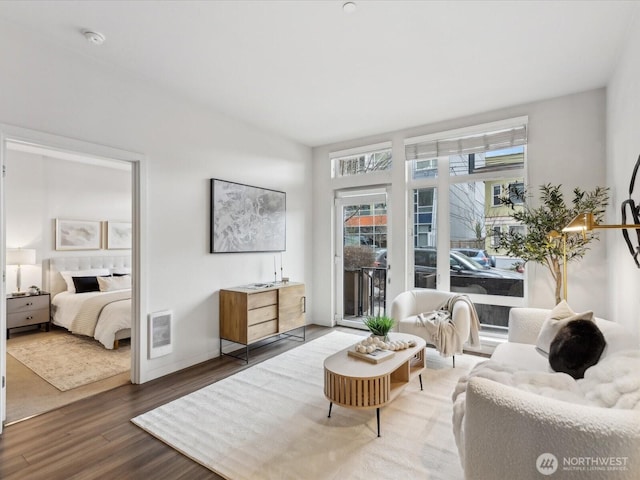 sitting room with baseboards and wood finished floors