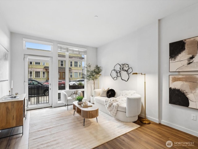 living room with baseboards and wood finished floors