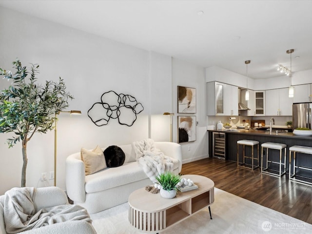 living room featuring beverage cooler and dark wood-style flooring