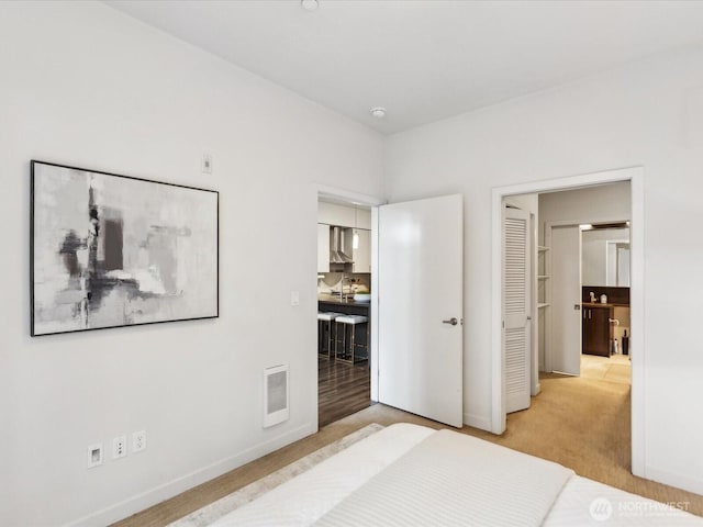 carpeted bedroom with visible vents and baseboards