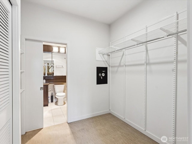 spacious closet with tile patterned floors