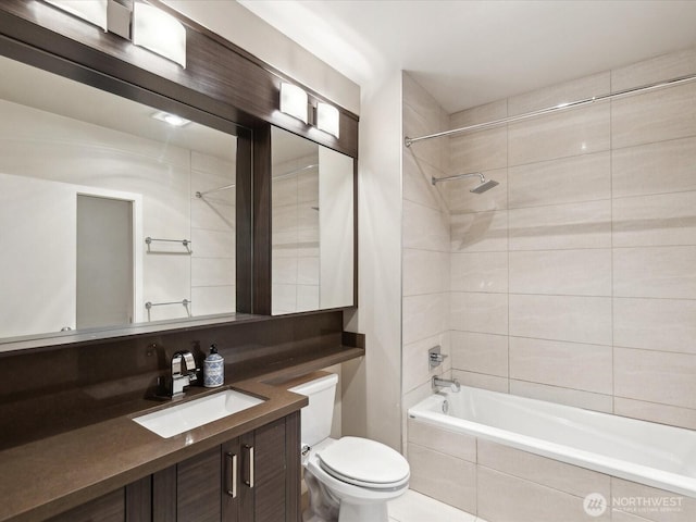 full bathroom featuring toilet, vanity, and tiled shower / bath combo