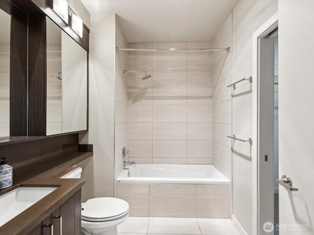 full bath with toilet, tile patterned flooring, tiled shower / bath, and vanity