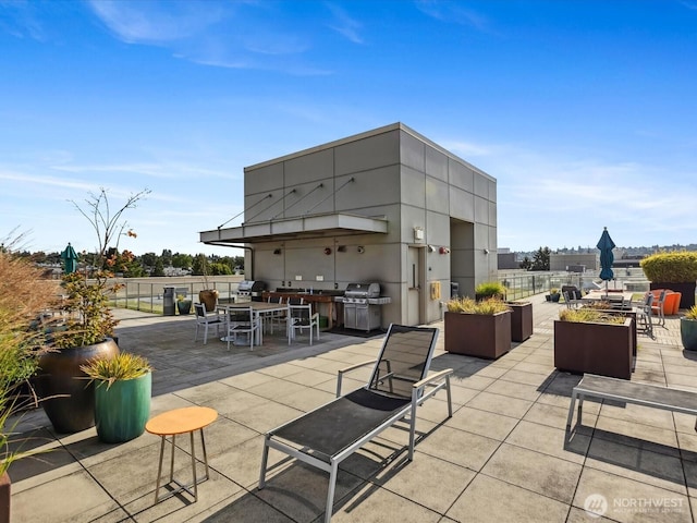 view of patio featuring outdoor dining area, area for grilling, and fence