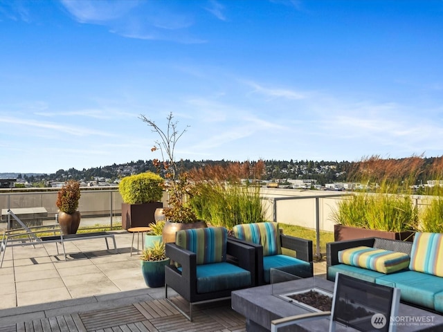 view of patio / terrace with an outdoor living space with a fire pit