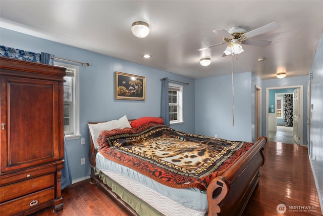 bedroom featuring baseboards and dark wood-type flooring