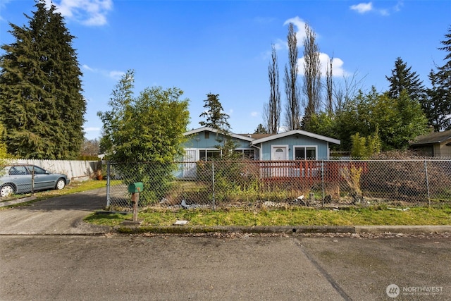 view of front of home with driveway and a fenced front yard