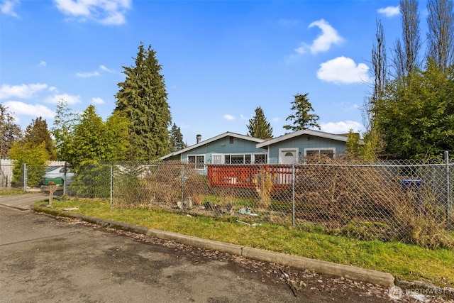 view of front of home featuring fence private yard and a deck