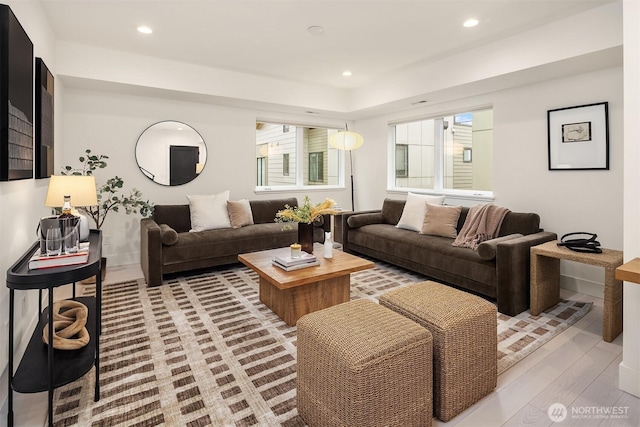 living area with light wood-style flooring and recessed lighting