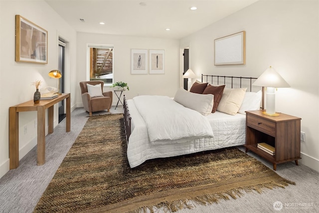 carpeted bedroom featuring baseboards and recessed lighting