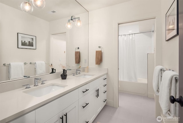 bathroom with double vanity, shower / tub combo, a sink, and visible vents