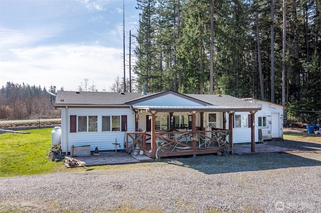 single story home with a shingled roof and a front lawn