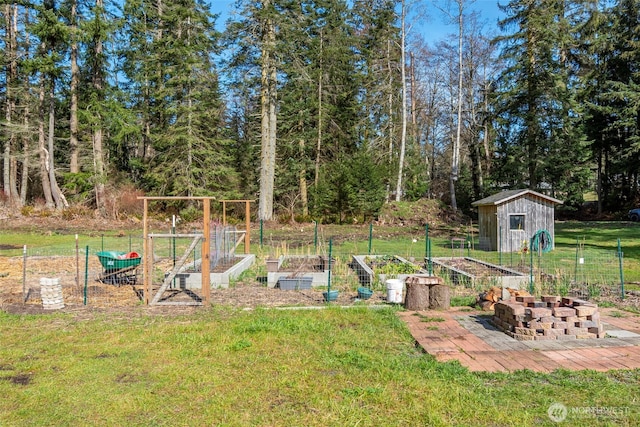 view of yard featuring an outbuilding, a shed, and a garden