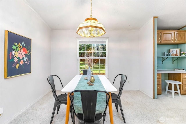 dining room with light carpet, baseboards, and crown molding