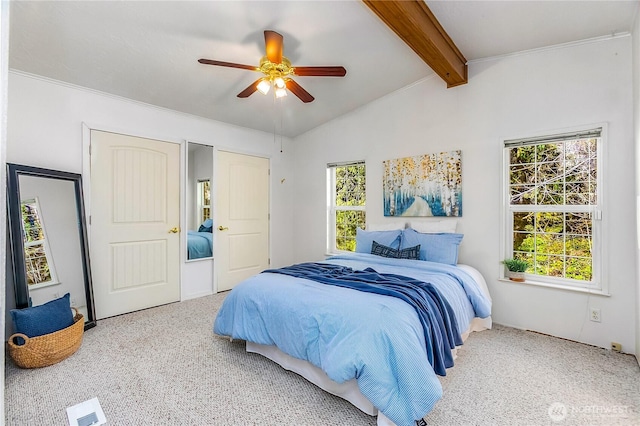 carpeted bedroom featuring lofted ceiling with beams, ceiling fan, and visible vents