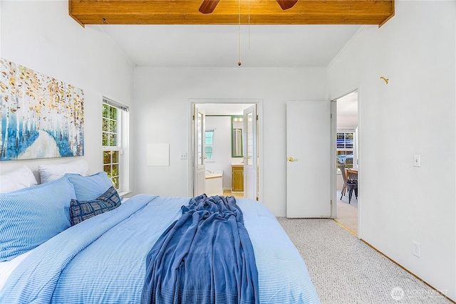 carpeted bedroom featuring ensuite bathroom, a ceiling fan, beam ceiling, and crown molding