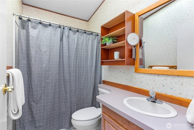 bathroom with wallpapered walls, toilet, a shower with curtain, ornamental molding, and vanity