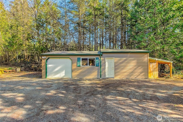 detached garage featuring driveway